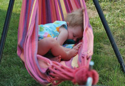 Toddler naps in a hammock sling