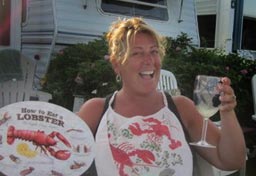 Woman wearing lobster bib raises a wine glass